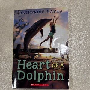 Scholastic Heart of a Dolphin Book with Black and Green Cover